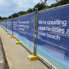 Load image into Gallery viewer, Fence with promotional banner for beach facilities development